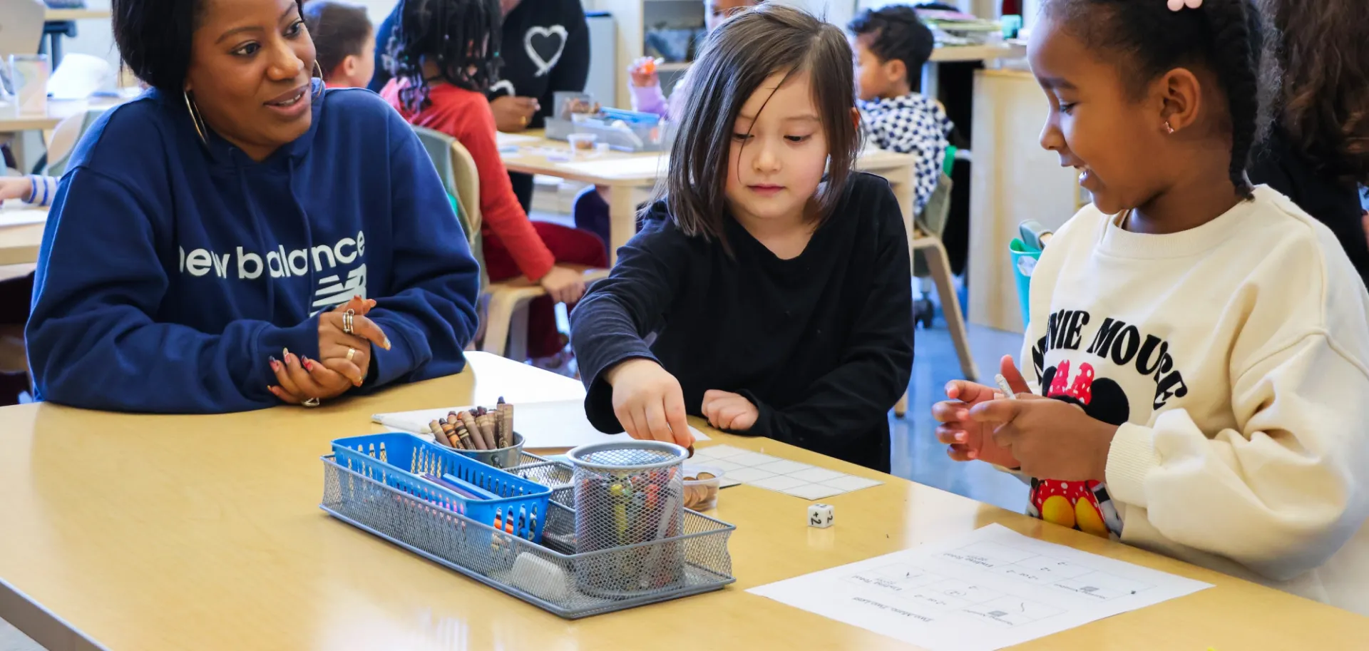 teacher and students at desk