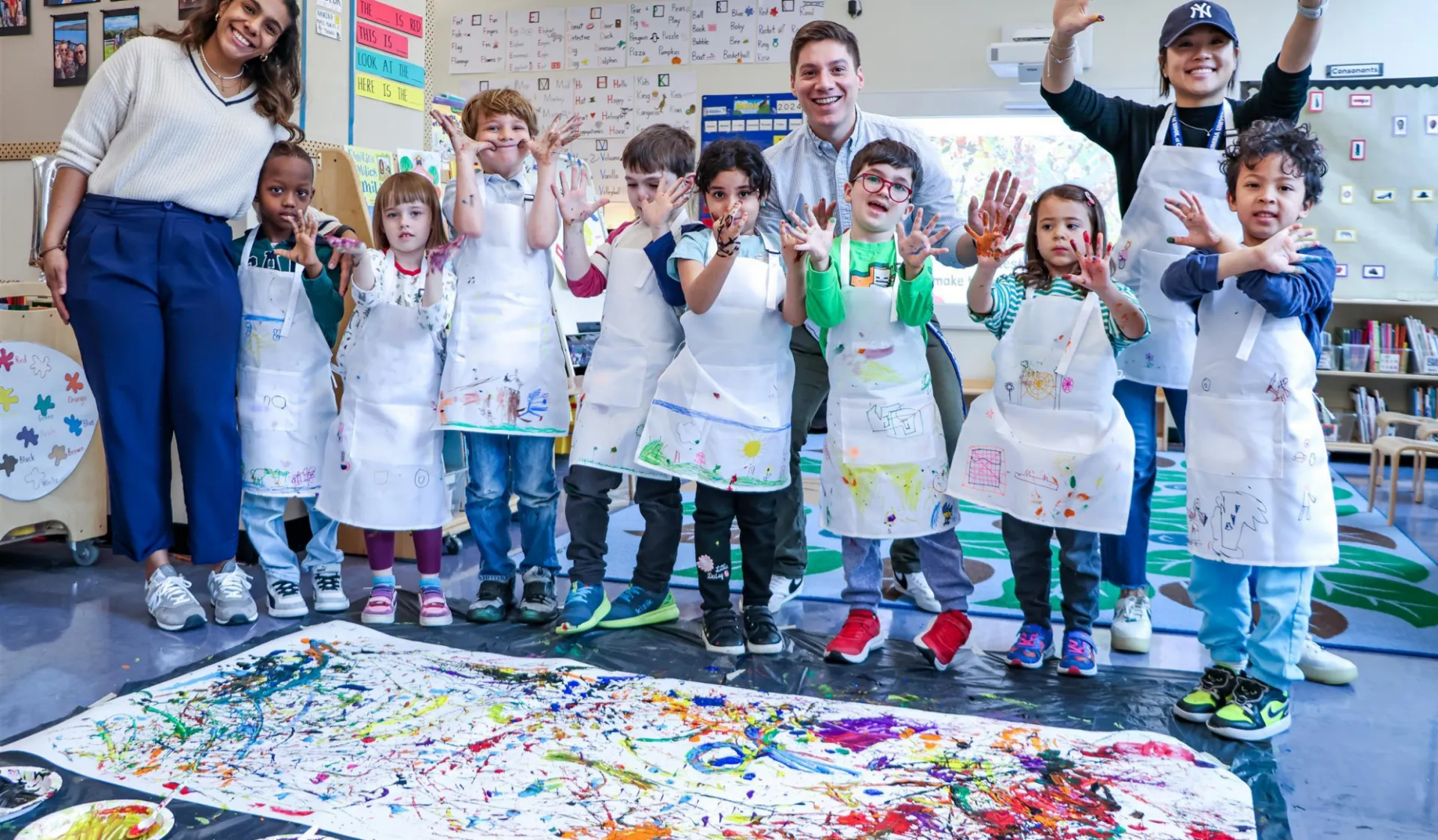 students and teachers with pain on hands smiling