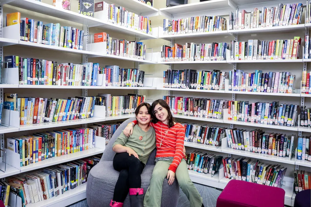 students smiling in the library